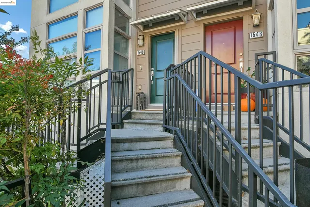a view of a chair and table in backyard of the house