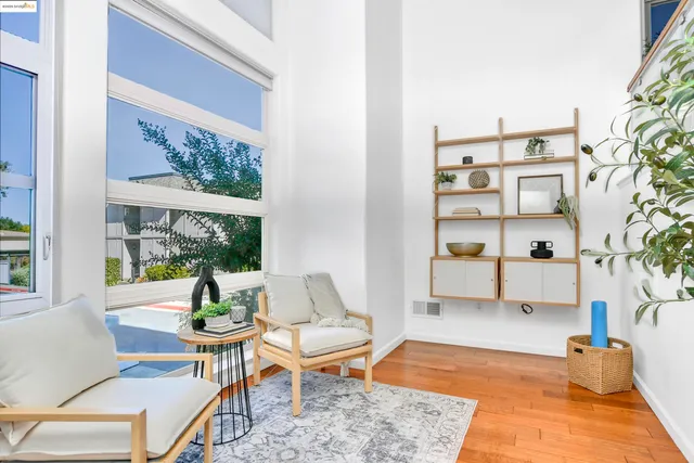 a living room with fireplace furniture and a wooden floor
