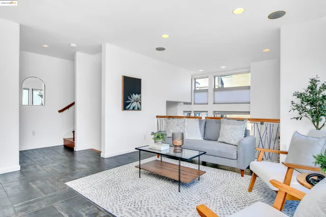 a living room with furniture fireplace and wooden floor