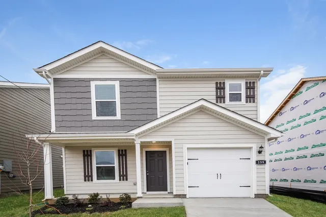 a front view of a house with a yard
