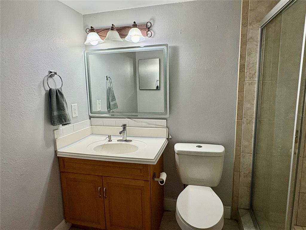 310 Cherokee Court, Unit D Altamonte Springs, FL 32701 - Photo 11 of 22 a bathroom with a toilet sink and mirror