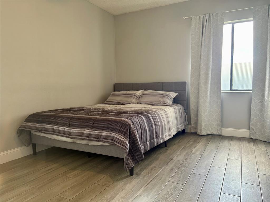 310 Cherokee Court, Unit D Altamonte Springs, FL 32701 - Photo 12 of 22 a bedroom with a bed and a window