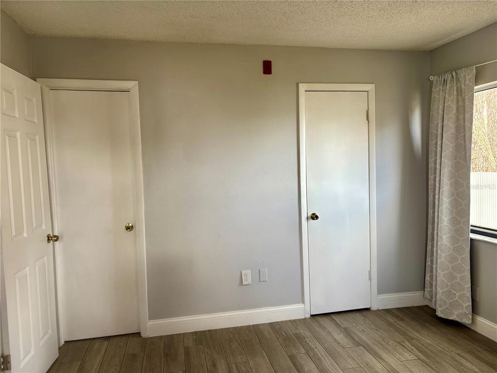 310 Cherokee Court, Unit D Altamonte Springs, FL 32701 - Photo 13 of 22 a view of an empty room with wooden floor and closet