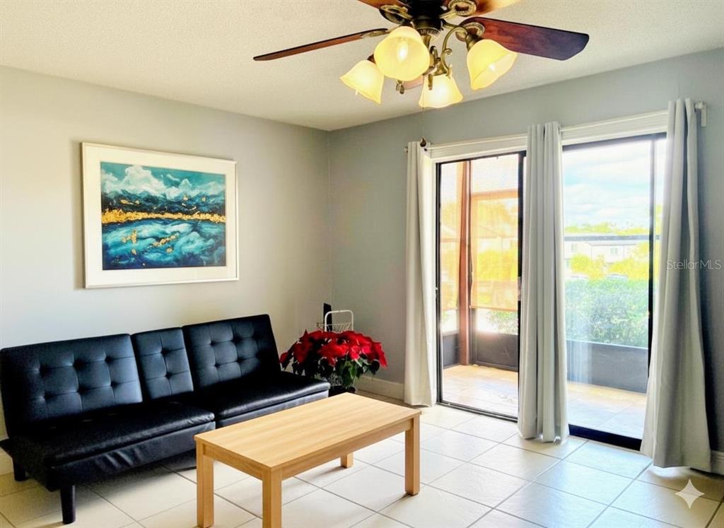 310 Cherokee Court, Unit D Altamonte Springs, FL 32701 - Photo 4 of 22 a living room with furniture and a chandelier