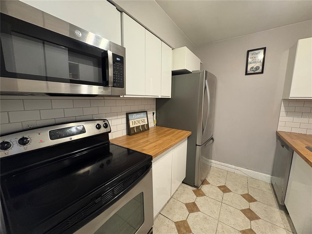 310 Cherokee Court, Unit D Altamonte Springs, FL 32701 - Photo 7 of 22 a kitchen with stainless steel appliances and cabinets