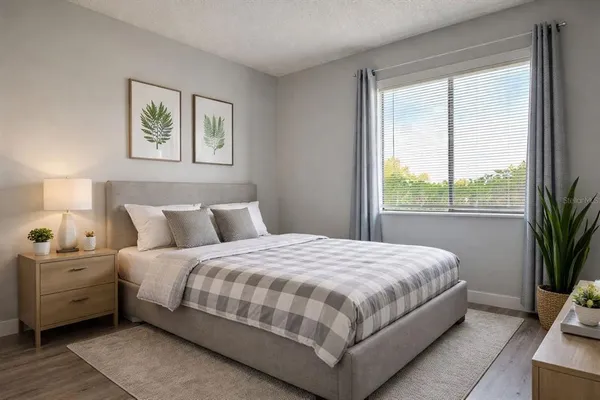 a bedroom with a large bed and a large window