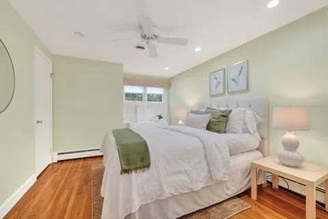 a spacious bedroom with a bed and a window