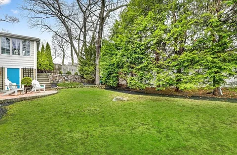 a view of yard with swimming pool and green space