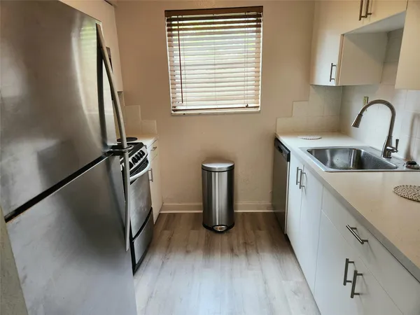 a kitchen with refrigerator and window