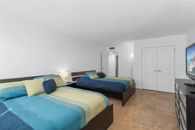 a bedroom with two beds and painted walls