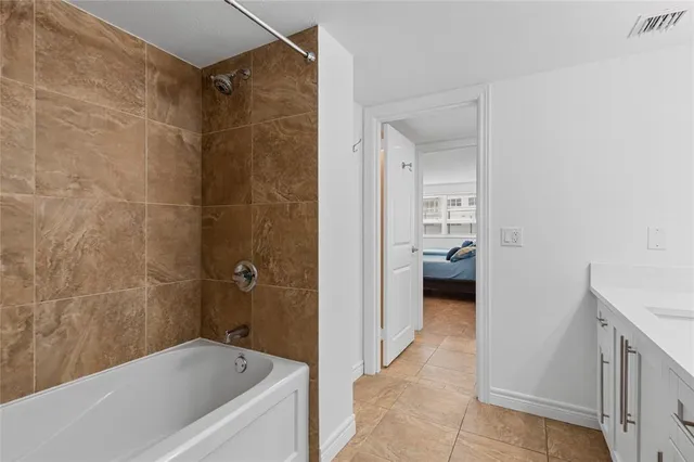 a bathroom with a tub and a hallway