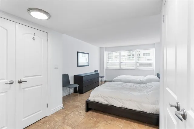 a bedroom with bed and window