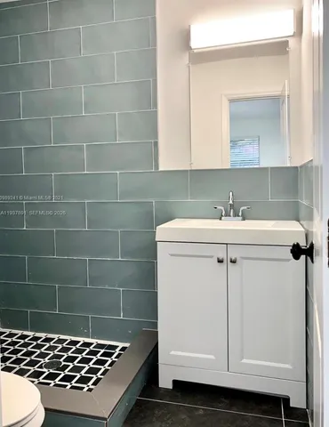 a bathroom with a sink toilet a shower and a mirror