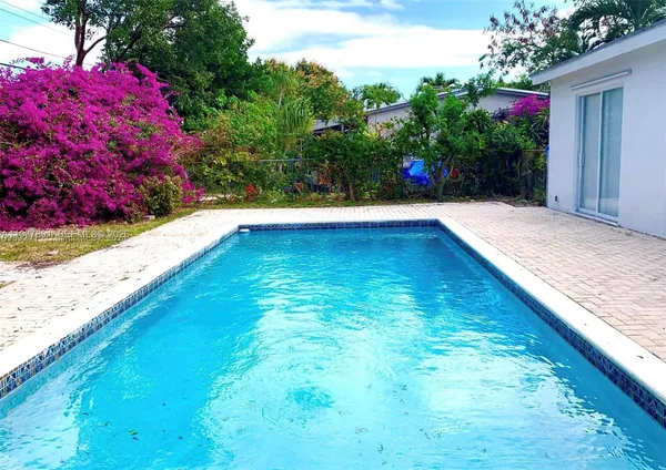 a view of swimming pool with a yard