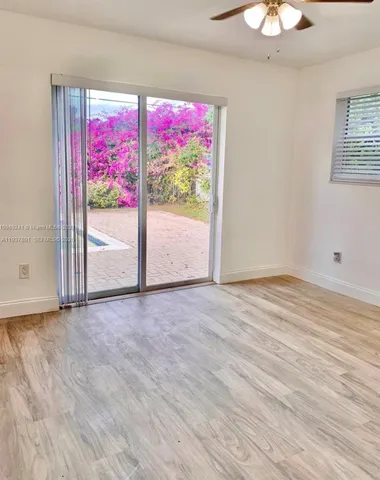 a view of a room with wooden floor and window