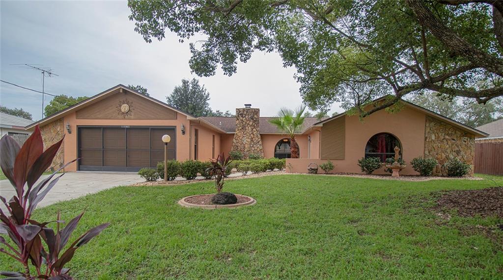 11078 Belltower Street Spring Hill, FL 34608 - Photo 1 of 1 a front view of a house with a yard and garage