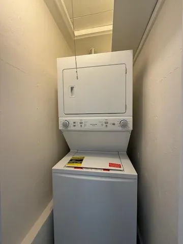 a close up of a washer dryer with white walls