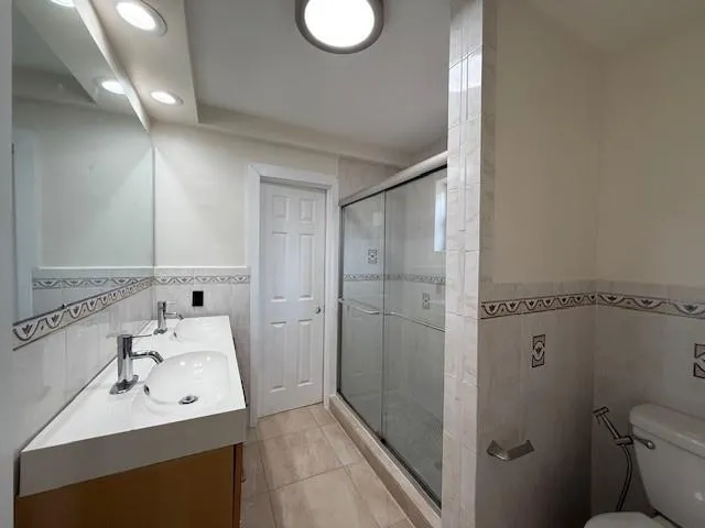 a bathroom with a sink toilet and shower