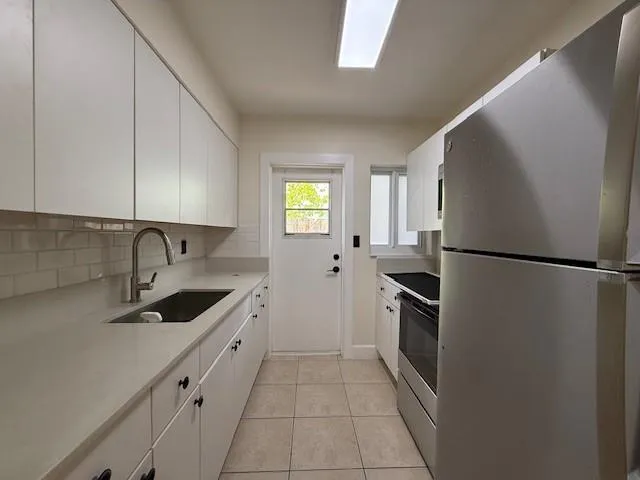 a kitchen with a sink and a refrigerator