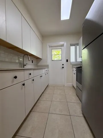 a kitchen with a cabinets and window