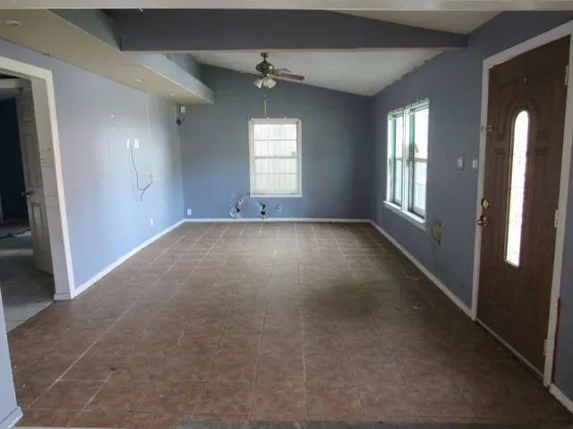 a view of an empty room with a window