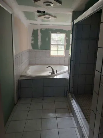 a bathroom with a bathtub and sink
