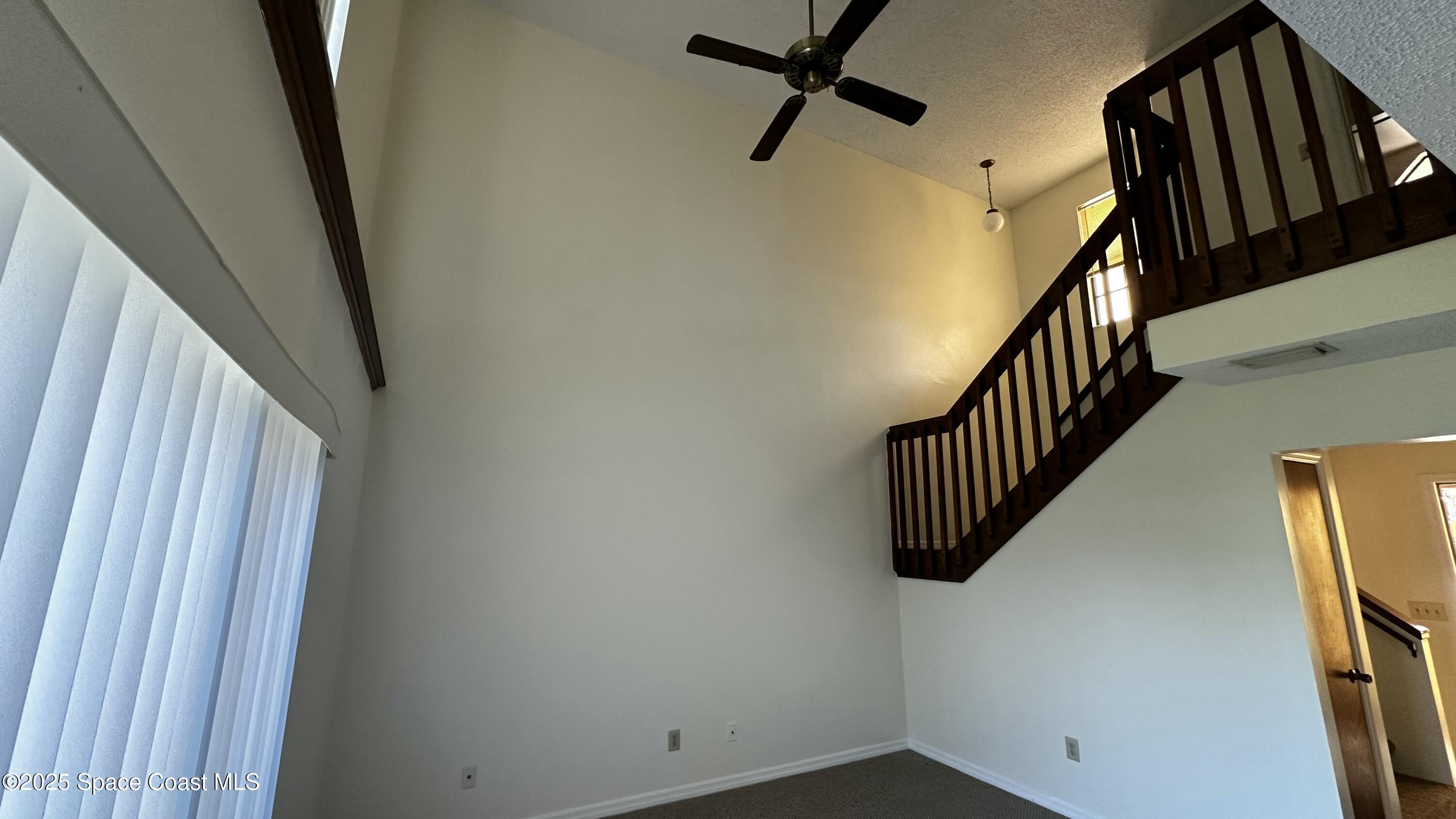 2710 Park Pl Boulevard, Unit 4 Melbourne, FL 32935 - Photo 12 of 16 a view of staircase with railing and white walls
