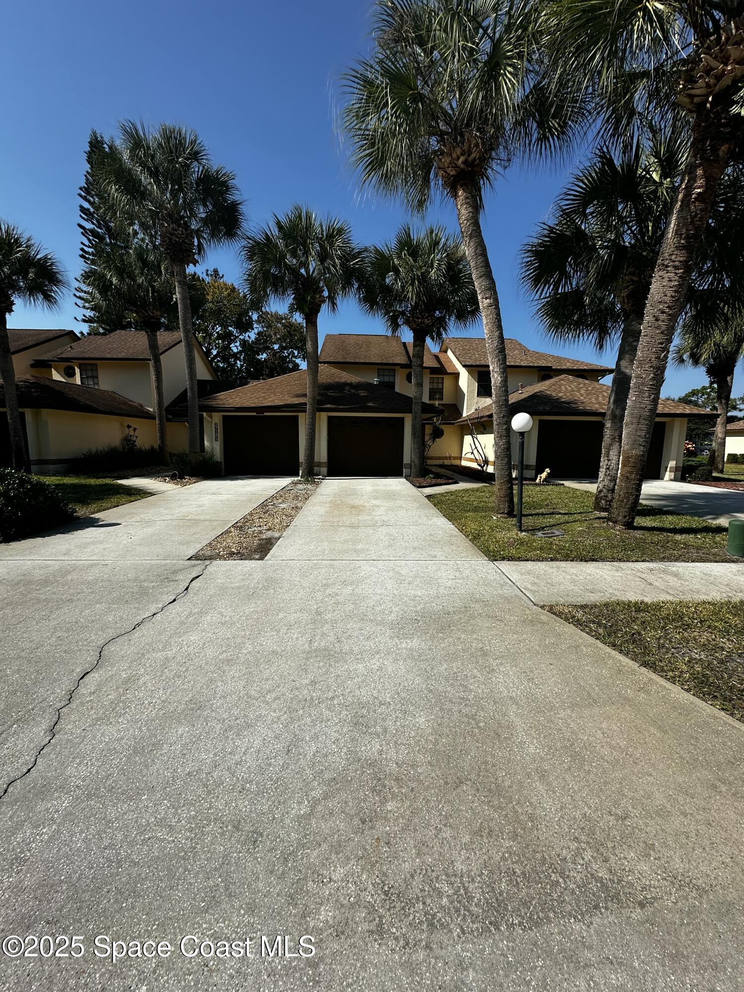 2710 Park Pl Boulevard, Unit 4 Melbourne, FL 32935 - Photo 13 of 16 a view of a house with a yard
