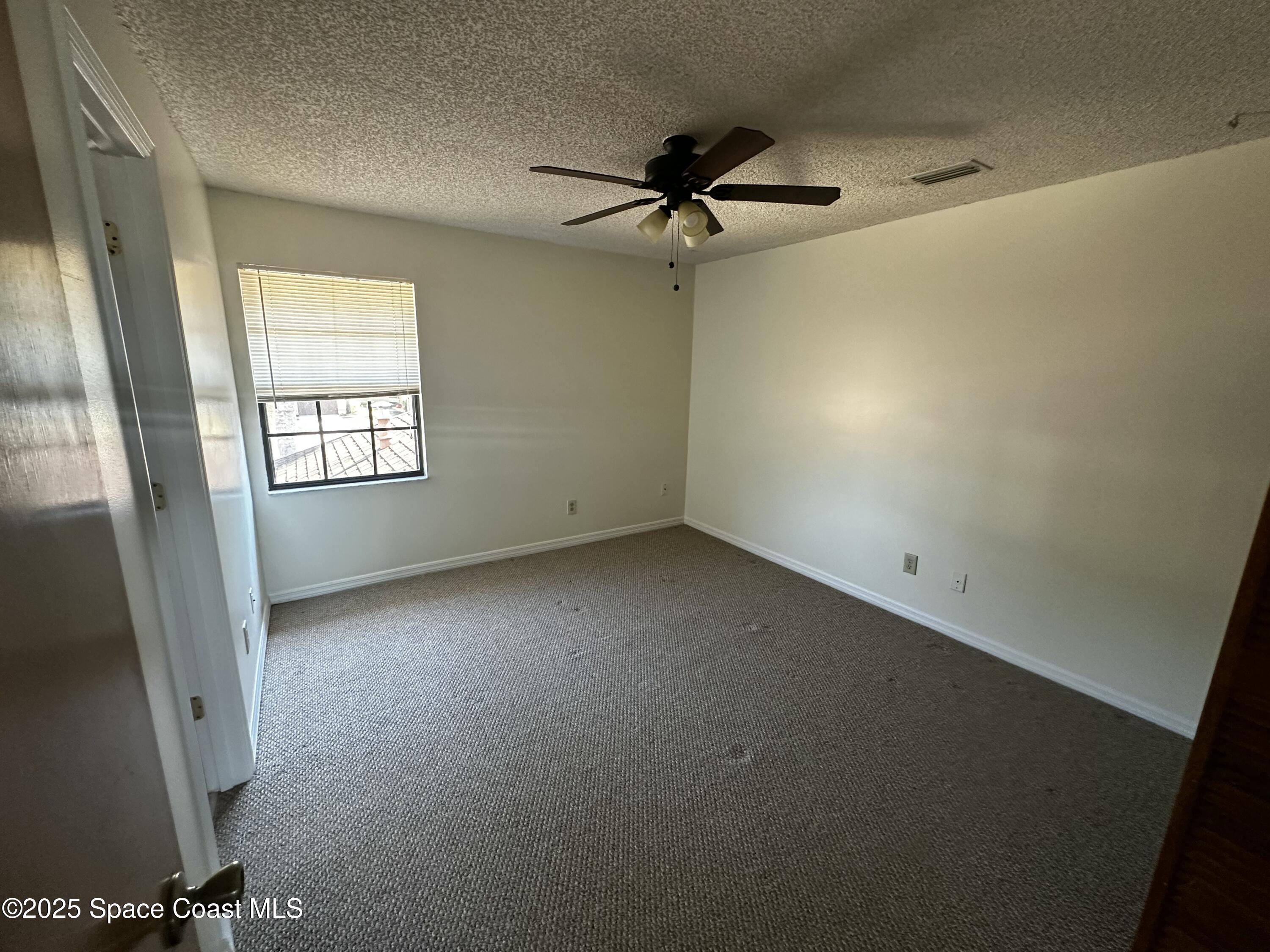 2710 Park Pl Boulevard, Unit 4 Melbourne, FL 32935 - Photo 15 of 16 an empty room with a window