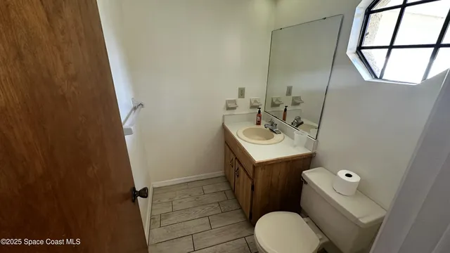 a bathroom with a sink toilet and mirror