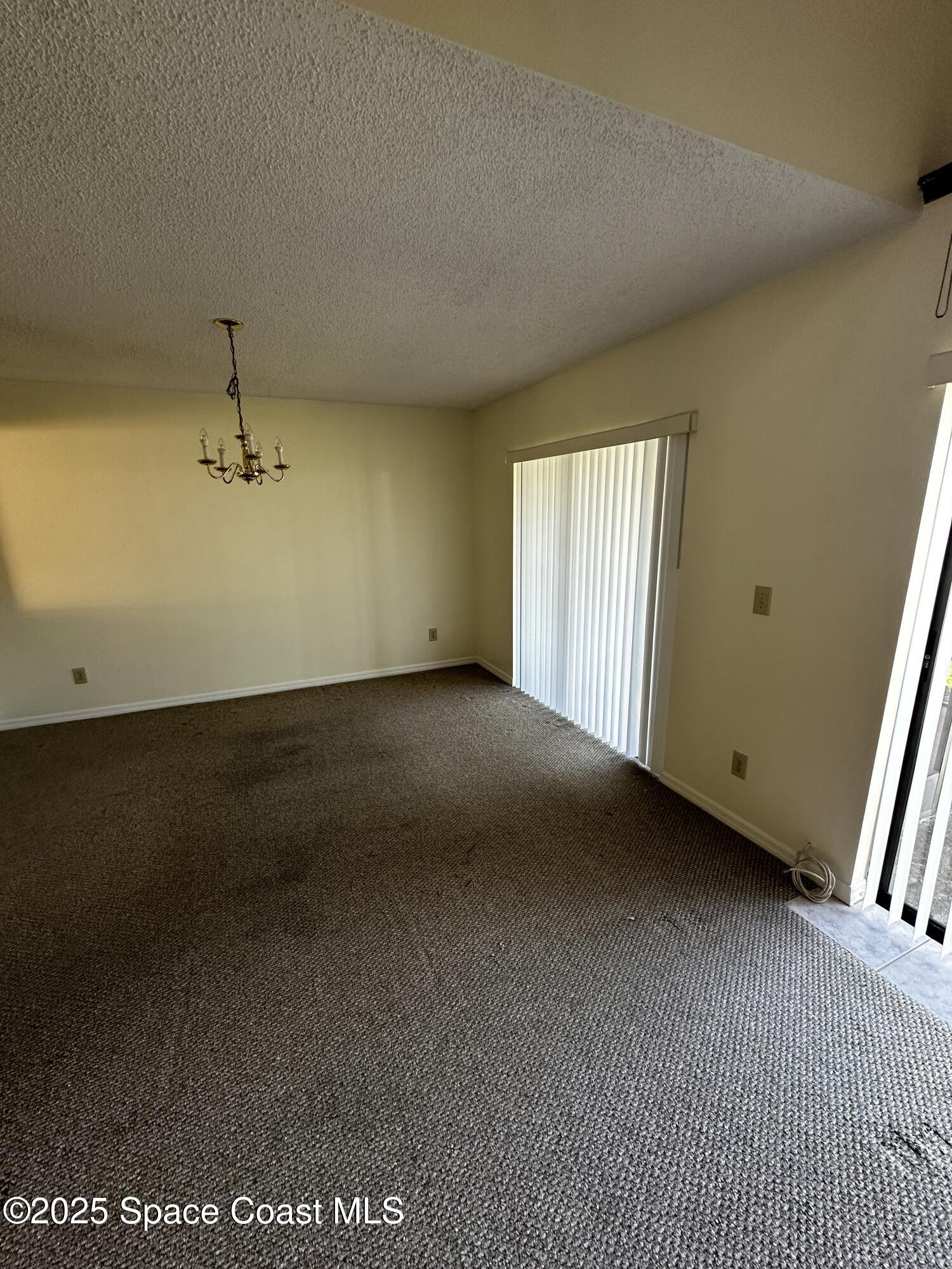 2710 Park Pl Boulevard, Unit 4 Melbourne, FL 32935 - Photo 4 of 16 an empty room with windows