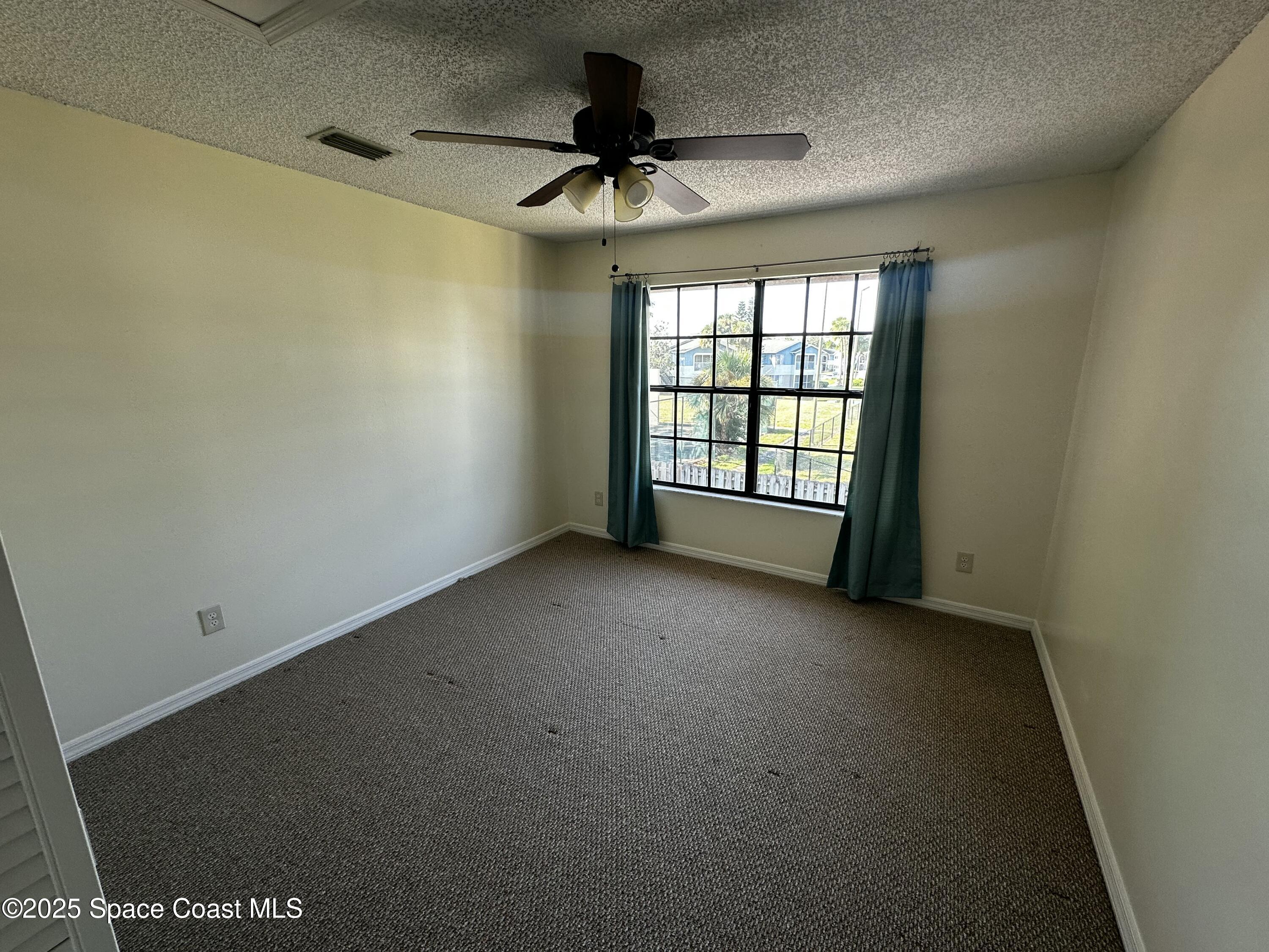 2710 Park Pl Boulevard, Unit 4 Melbourne, FL 32935 - Photo 5 of 16 a view of an empty room with a window