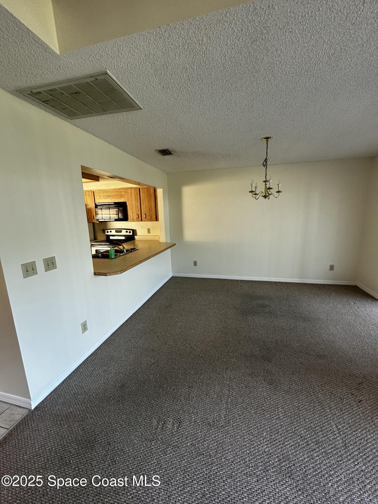 2710 Park Pl Boulevard, Unit 4 Melbourne, FL 32935 - Photo 9 of 16 a view of a room with a flat screen tv