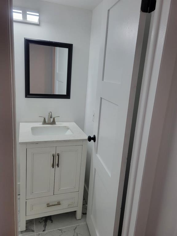 4222 Inverrary Boulevard, Unit 4413 Lauderhill, FL 33319 - Photo 11 of 34 a bathroom with a sink vanity and mirror