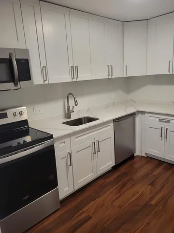 a view of a hallway with washer and dryer