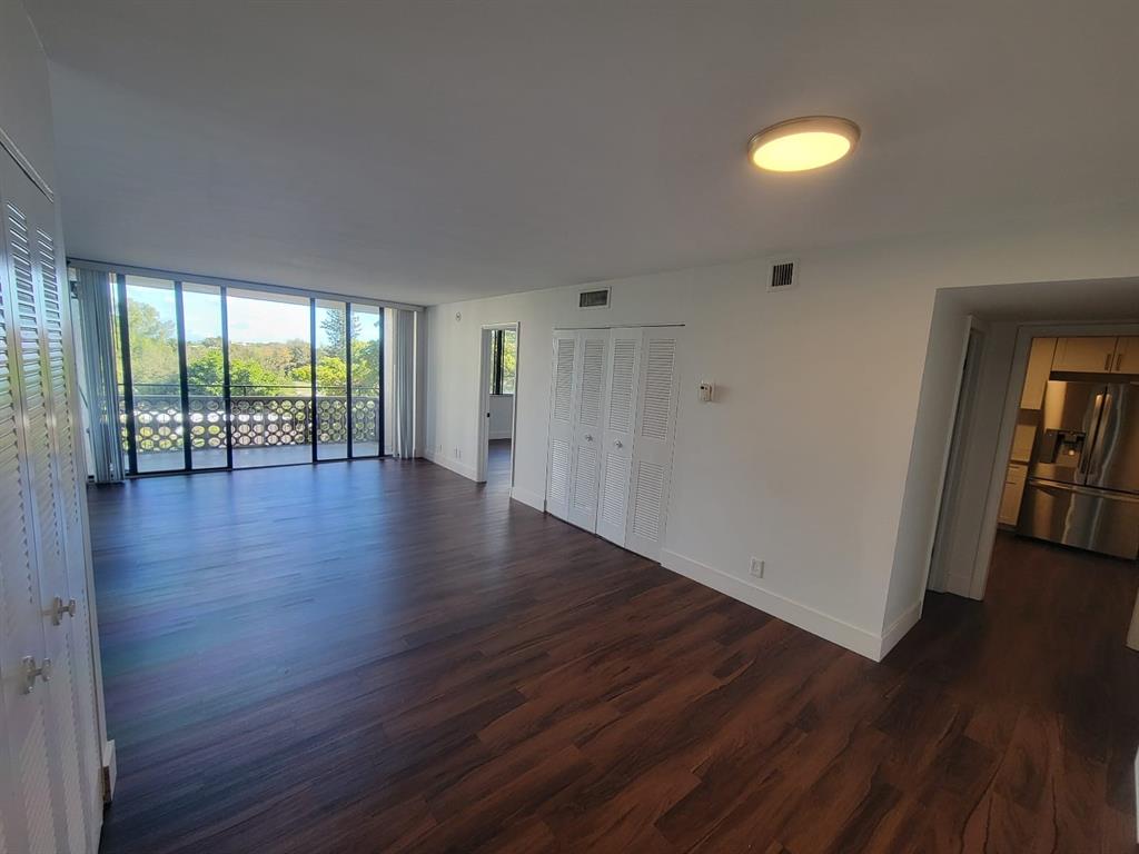 4222 Inverrary Boulevard, Unit 4413 Lauderhill, FL 33319 - Photo 15 of 34 a view of an empty room with wooden floor and a window