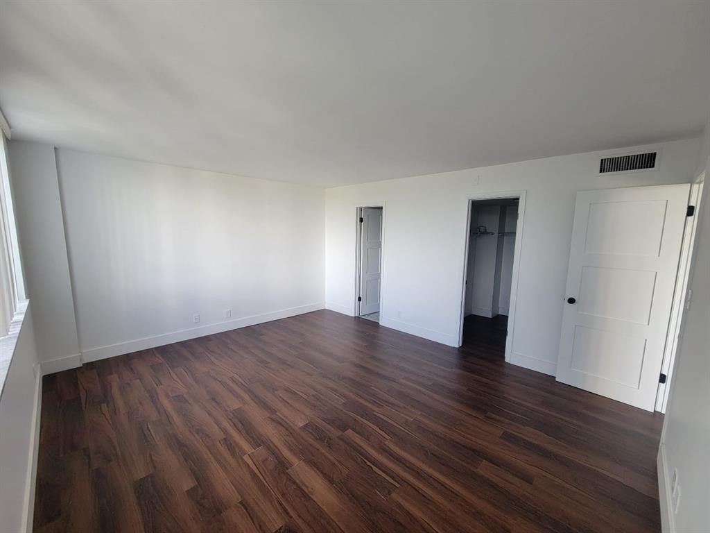 4222 Inverrary Boulevard, Unit 4413 Lauderhill, FL 33319 - Photo 18 of 34 a view of an empty room with wooden floor and a window