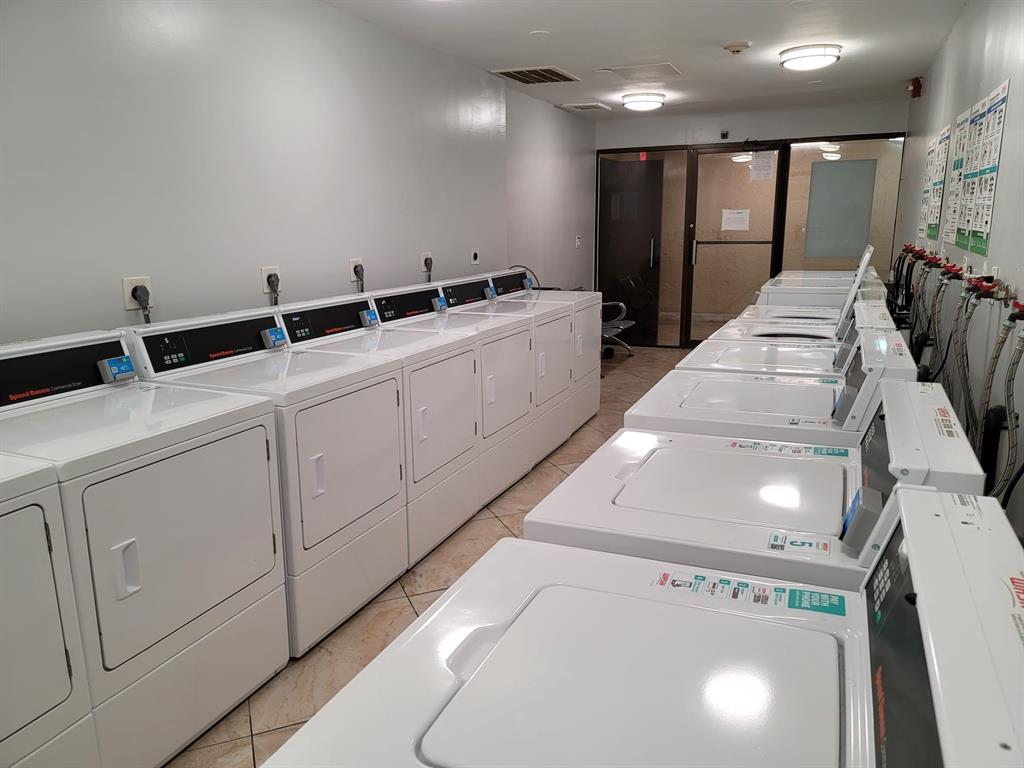 4222 Inverrary Boulevard, Unit 4413 Lauderhill, FL 33319 - Photo 30 of 34 a view of a hallway with washer and dryer