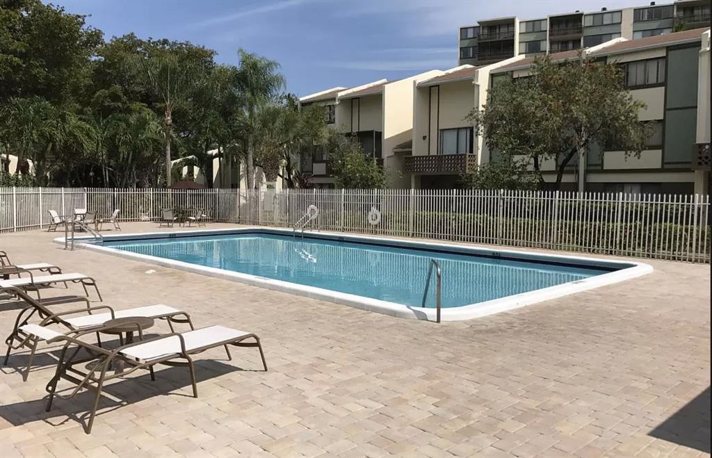 4222 Inverrary Boulevard, Unit 4413 Lauderhill, FL 33319 - Photo 33 of 34 a view of a swimming pool with a lounge chairs