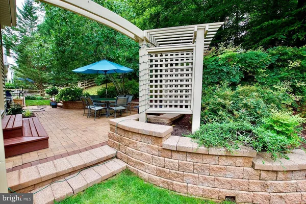 a view of a patio with a table and chairs under an umbrella