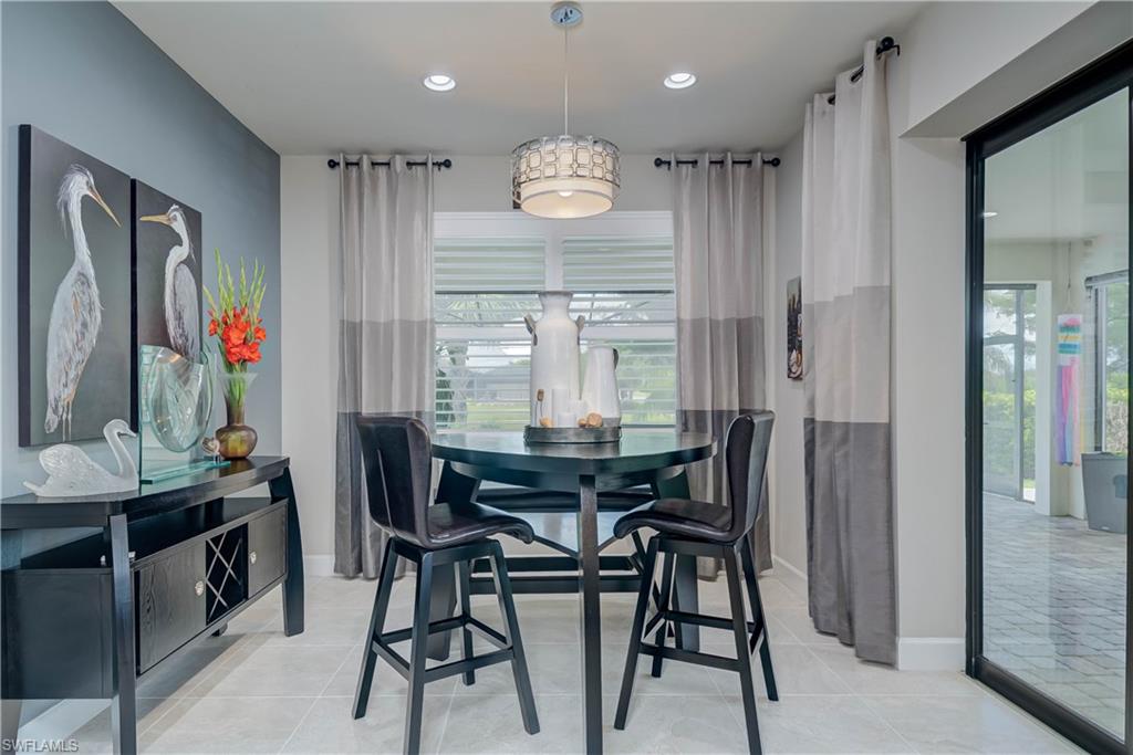 7938 Guadiana Way Ave Maria, FL 34142 - Photo 12 of 37 a view of a dining room with furniture window and wooden floor