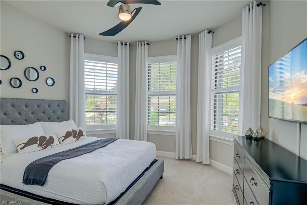 7938 Guadiana Way Ave Maria, FL 34142 - Photo 18 of 37 a bedroom with a bed and a window