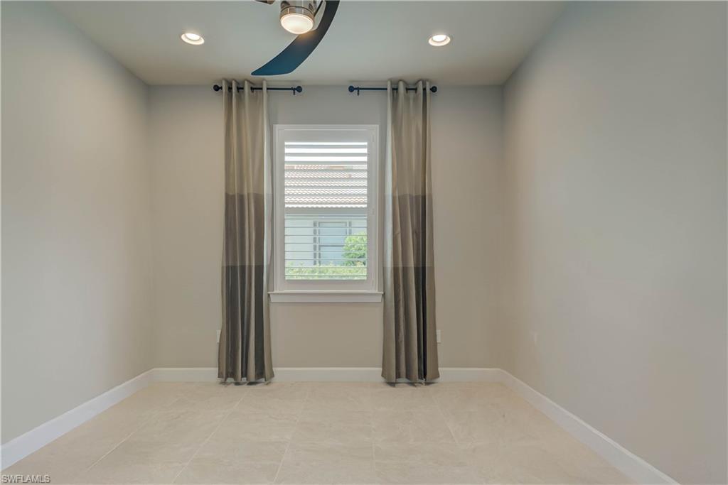 7938 Guadiana Way Ave Maria, FL 34142 - Photo 21 of 37 an empty room with windows
