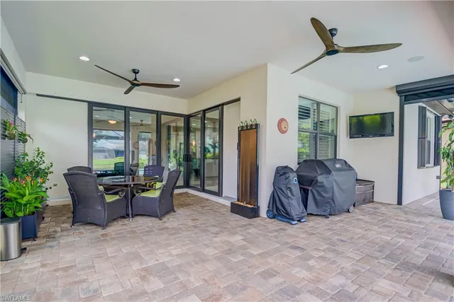 a view of a porch with furniture and a yard
