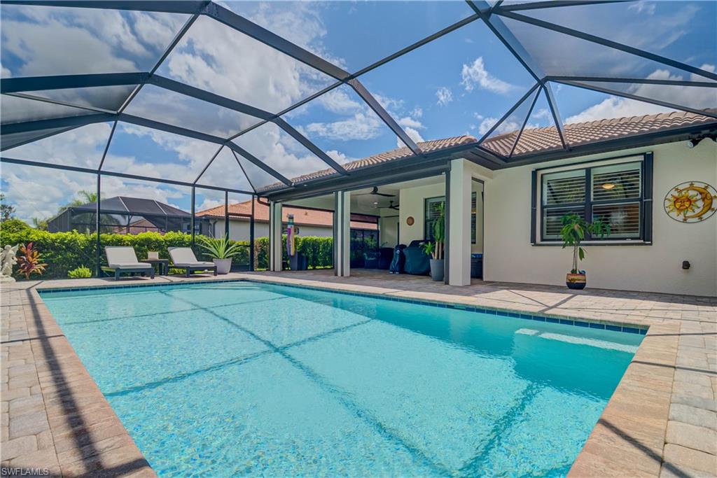 7938 Guadiana Way Ave Maria, FL 34142 - Photo 26 of 37 a view of a backyard with a patio and a garden