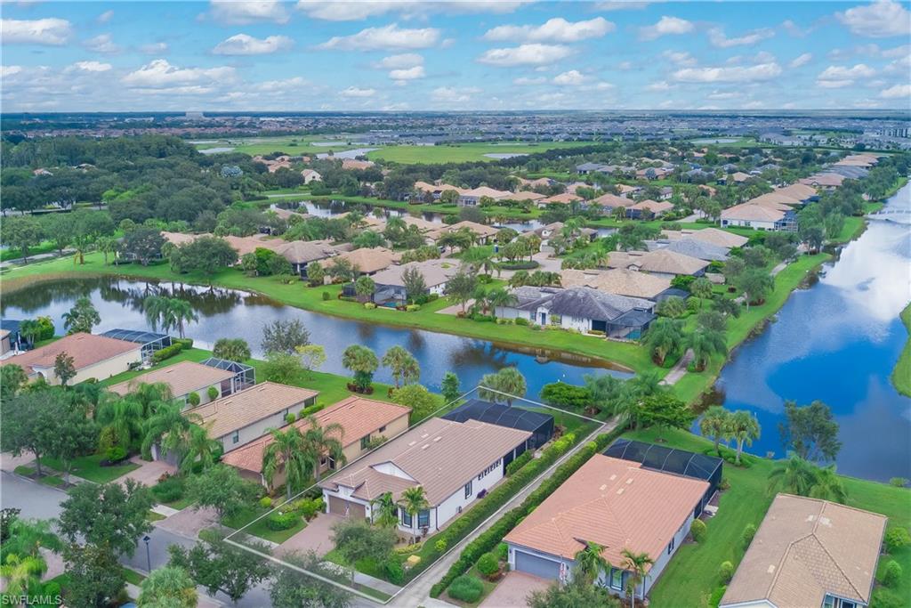 7938 Guadiana Way Ave Maria, FL 34142 - Photo 28 of 37 an aerial view of residential houses with outdoor space and river