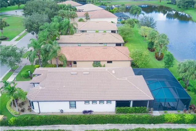 an aerial view of residential houses with outdoor space and river