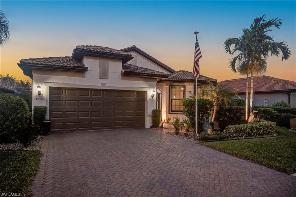 7938 Guadiana Way Ave Maria, FL 34142 - Photo 3 of 37 a view of a house with a small yard and potted plants