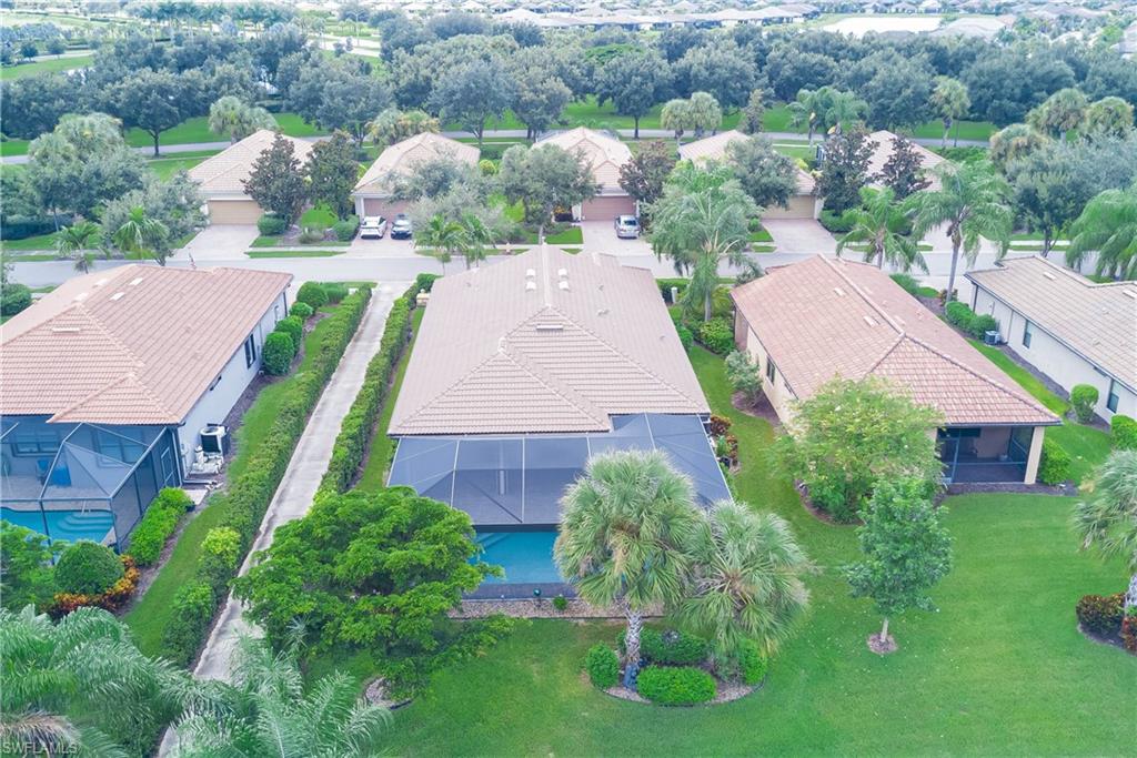 7938 Guadiana Way Ave Maria, FL 34142 - Photo 30 of 37 an aerial view of multiple houses with yard