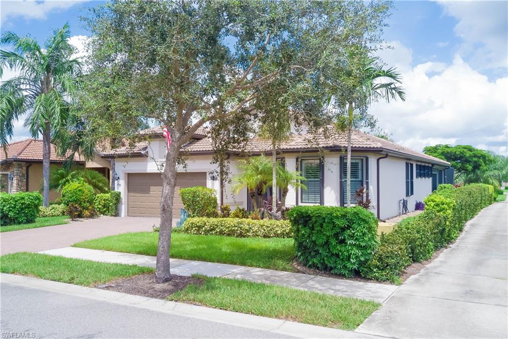 7938 Guadiana Way Ave Maria, FL 34142 - Photo 32 of 37 a front view of a house with a yard and potted plants